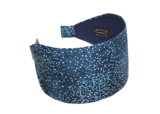 Blue headband with white polka dots on a white background